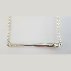 Custom sterling silver baseball bat pendant with a pearl accent.
