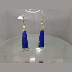 Beautiful 14k yellow gold earrings with a vibrant blue lapis stone. They each feature a brilliant cut diamond at the top and dangle by yellow gold lever backs. 