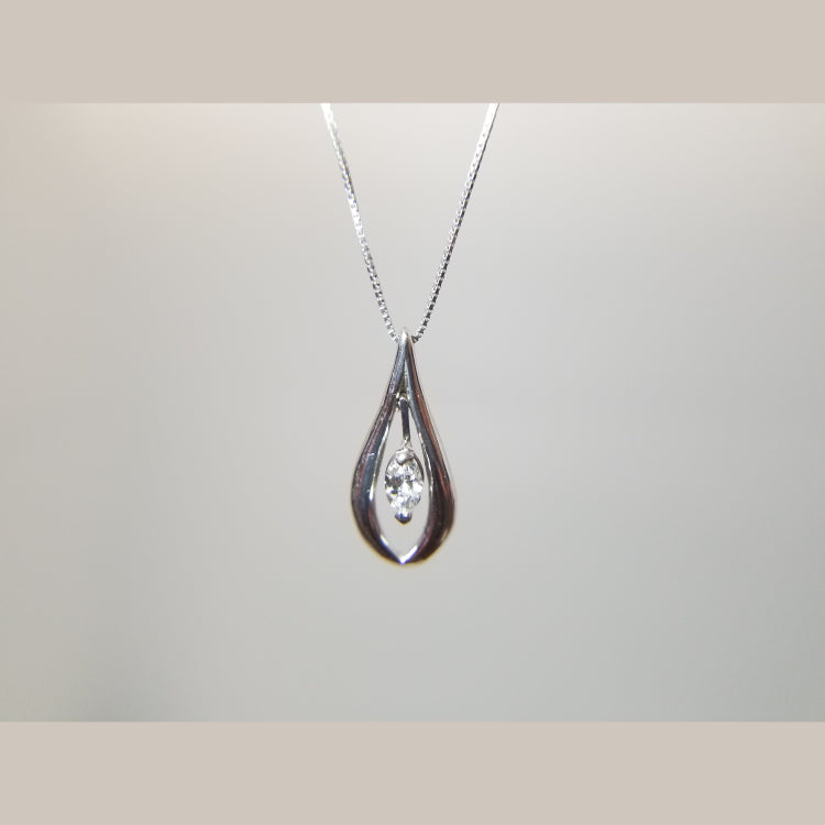 This custom pendant features a 0.17ct marquise "diamond in motion". It is set in a 14k white gold mounting, and hangs beautifully from a 18" white gold box chain 