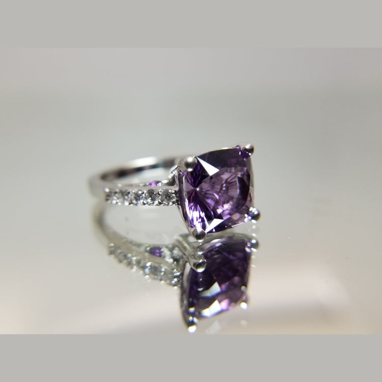 Custom 14k white gold diamond and amethyst ring. The ring features a 10.5 X 8.14mm Amethyst. 10 round diamonds with a total diamond weight of 0.48ct. 