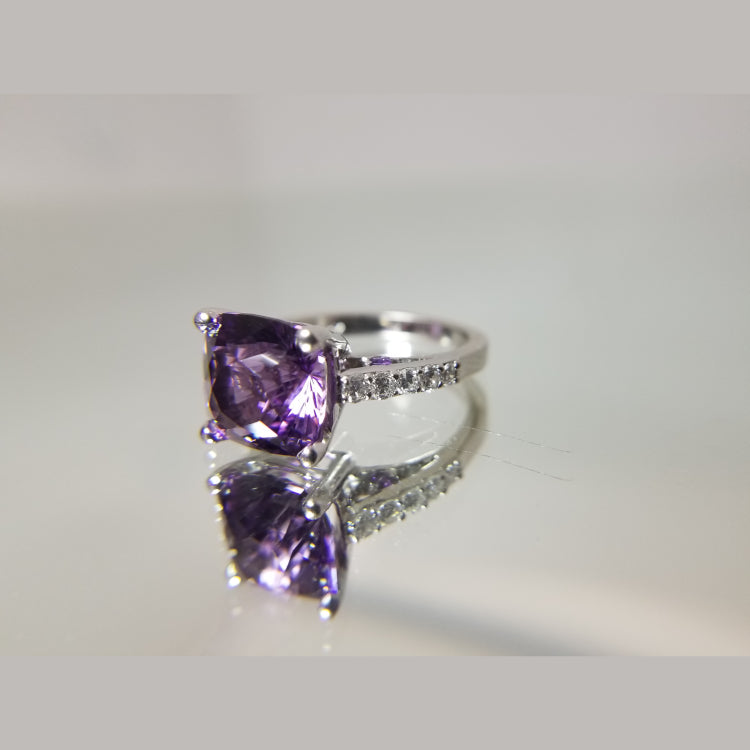 Custom 14k white gold diamond and amethyst ring. The ring features a 10.5 X 8.14mm Amethyst. 10 round diamonds with a total diamond weight of 0.48ct. 