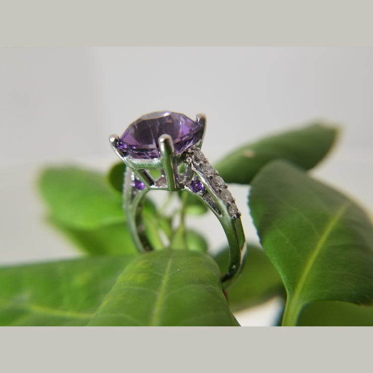 Custom 14k white gold diamond and amethyst ring. The ring features a 10.5 X 8.14mm Amethyst. 10 round diamonds with a total diamond weight of 0.48ct. 
