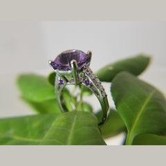 Custom 14k white gold diamond and amethyst ring. The ring features a 10.5 X 8.14mm Amethyst. 10 round diamonds with a total diamond weight of 0.48ct. 