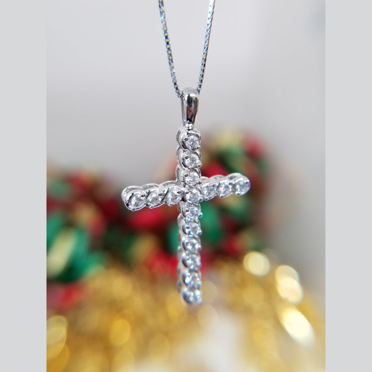 White gold and diamond cross pendant. 0.47ct total weight. Worn on 18" box chain.