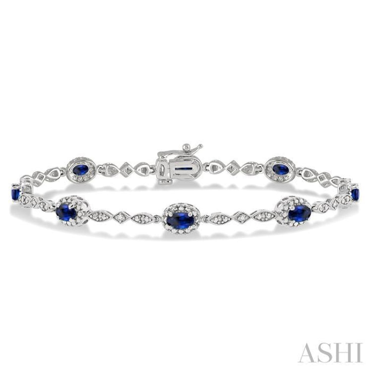 5x3 MM Oval Cut Sapphire and 1/20 Ctw Round Cut Diamond Bracelet in 14K White Gold